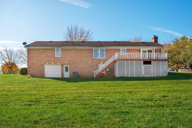 back of house featuring central AC, a garage, a yard, and a wooden deck