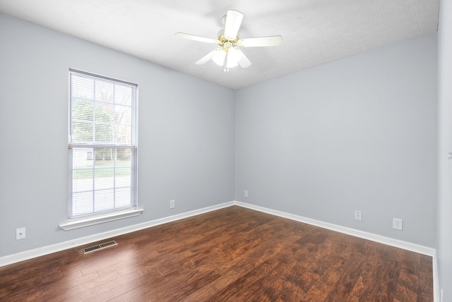 unfurnished room with a textured ceiling, dark hardwood / wood-style flooring, and ceiling fan