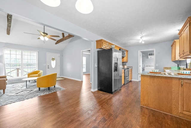 kitchen with vaulted ceiling with beams, washer / dryer, appliances with stainless steel finishes, dark wood-type flooring, and ceiling fan