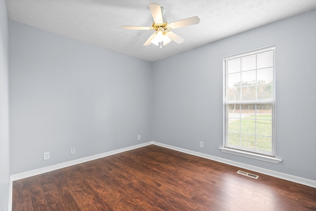 unfurnished room with dark hardwood / wood-style flooring, a textured ceiling, and ceiling fan