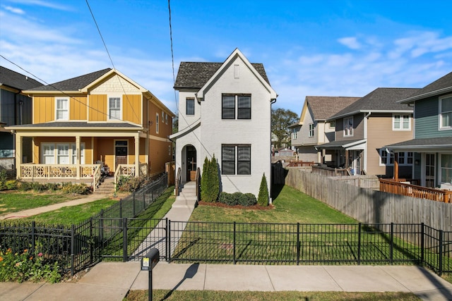 view of front of house featuring a front lawn and covered porch