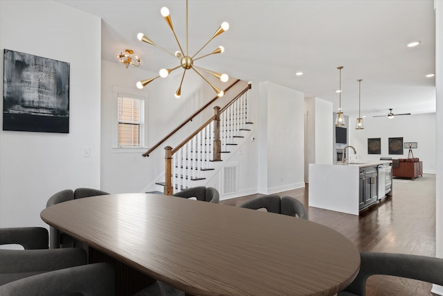 dining space featuring sink, dark hardwood / wood-style floors, and a notable chandelier