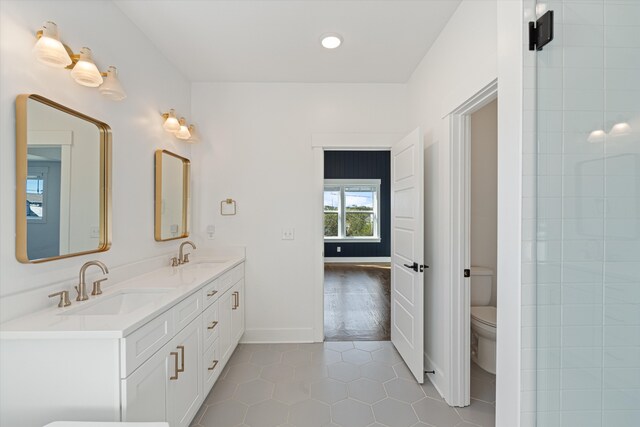 bathroom featuring tile patterned floors, vanity, and toilet