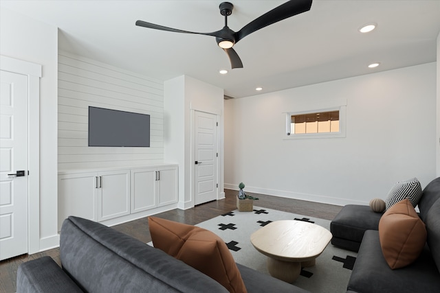 living room with ceiling fan and dark hardwood / wood-style floors