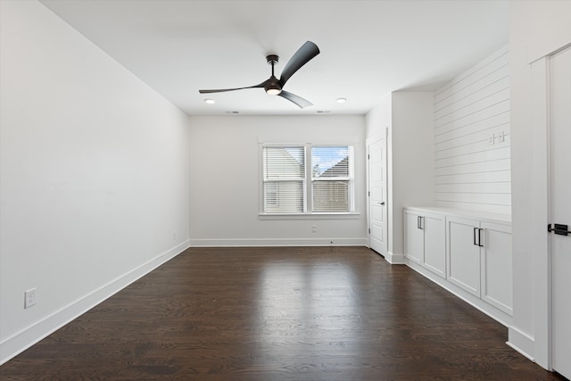 spare room featuring ceiling fan and dark hardwood / wood-style flooring