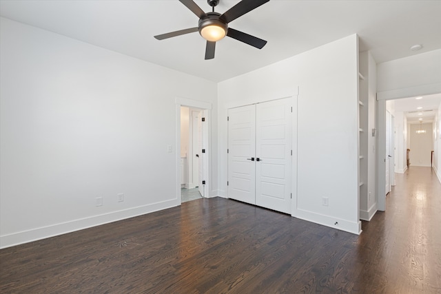 unfurnished bedroom with a closet, ceiling fan, and dark wood-type flooring