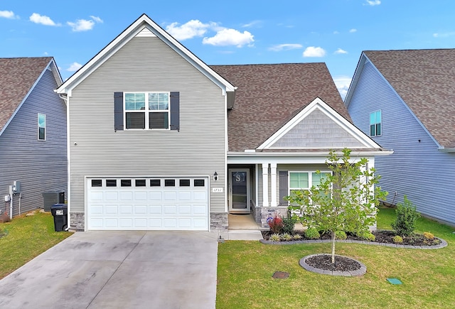 craftsman house with a garage and a front yard