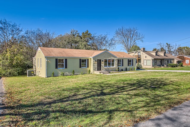 ranch-style home featuring central AC unit and a front yard