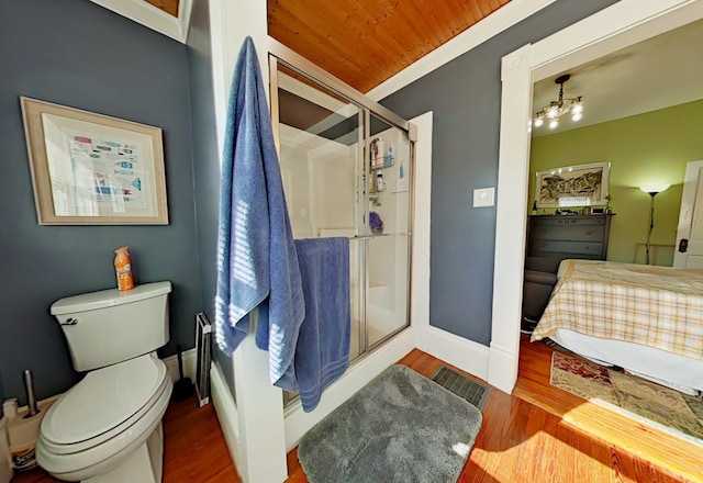 bathroom featuring hardwood / wood-style flooring, toilet, a shower with shower door, wood ceiling, and a chandelier