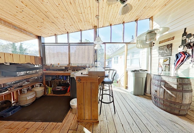 sunroom featuring wood ceiling and lofted ceiling