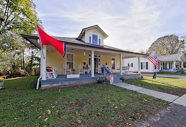 view of front of home with covered porch and a front lawn