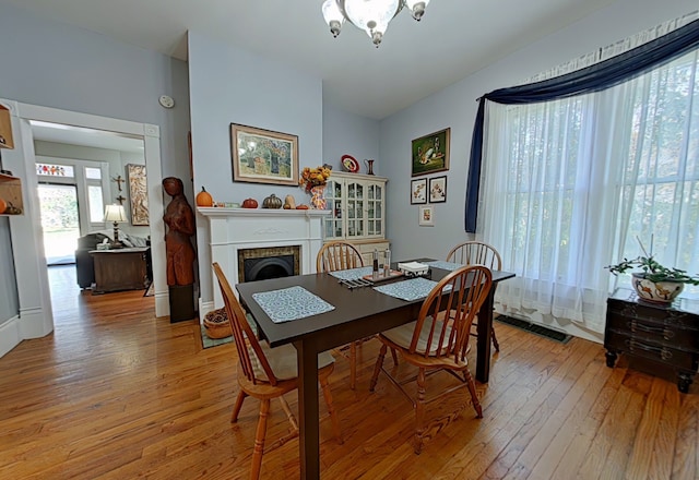 dining space with wood-type flooring and a notable chandelier