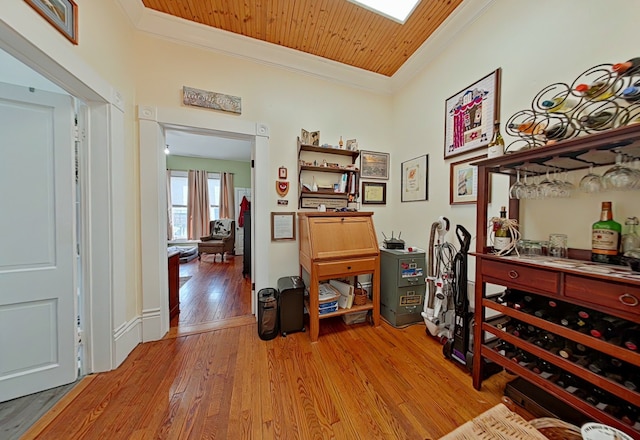 interior space featuring ornamental molding, wood ceiling, and light hardwood / wood-style flooring