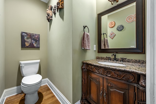 bathroom featuring hardwood / wood-style flooring, vanity, and toilet