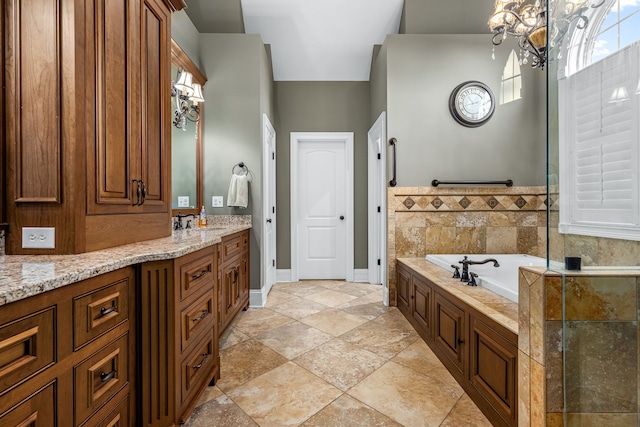 bathroom featuring vanity, a washtub, and an inviting chandelier