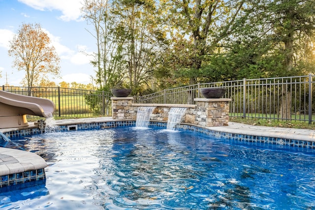 view of swimming pool featuring pool water feature and a water slide