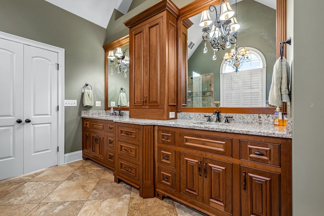 bathroom featuring vaulted ceiling, vanity, and a chandelier