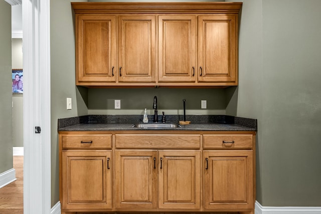 kitchen with sink and dark stone countertops