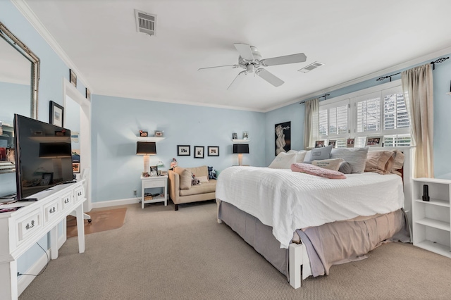 carpeted bedroom with ornamental molding and ceiling fan