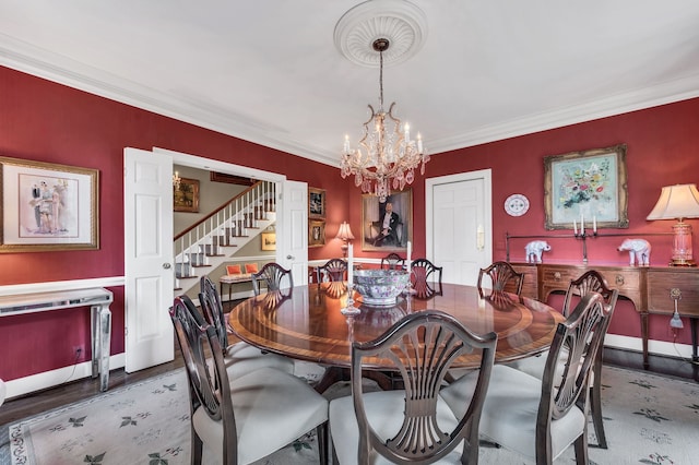 dining area with hardwood / wood-style floors, a chandelier, and crown molding