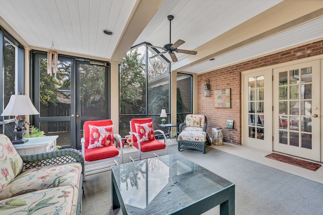 sunroom / solarium featuring ceiling fan and beam ceiling