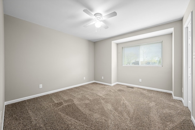 carpeted empty room featuring ceiling fan