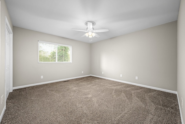 empty room with ceiling fan and carpet floors