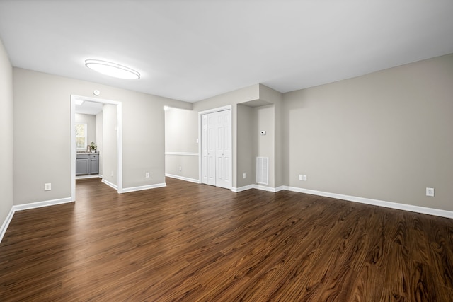 unfurnished room with dark wood-type flooring