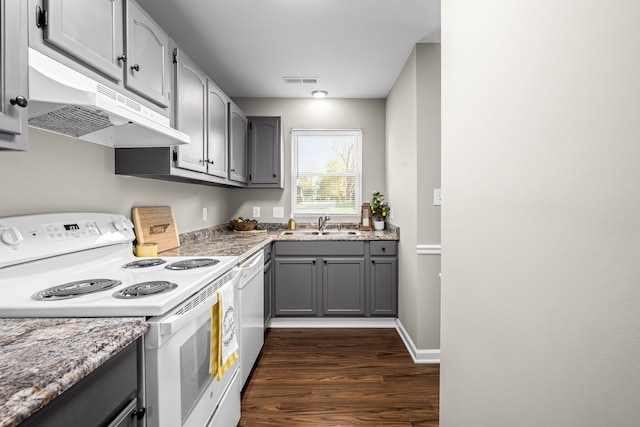 kitchen with gray cabinets, dark hardwood / wood-style flooring, white appliances, and sink