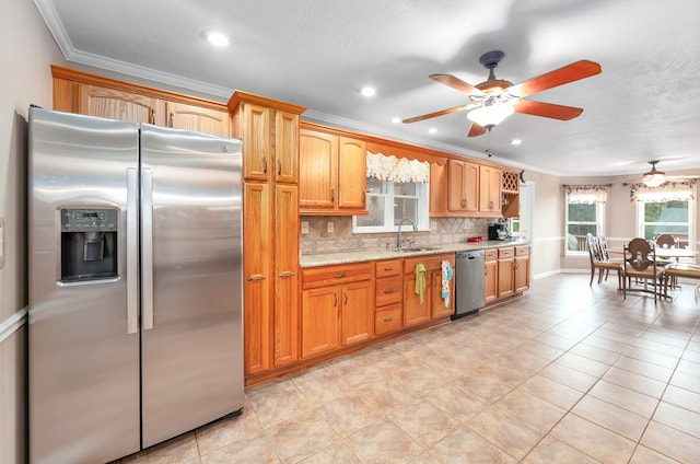 kitchen featuring light stone counters, decorative backsplash, sink, light tile patterned flooring, and appliances with stainless steel finishes