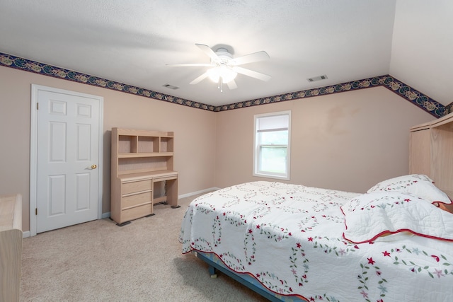 bedroom featuring a textured ceiling, lofted ceiling, ceiling fan, and light carpet