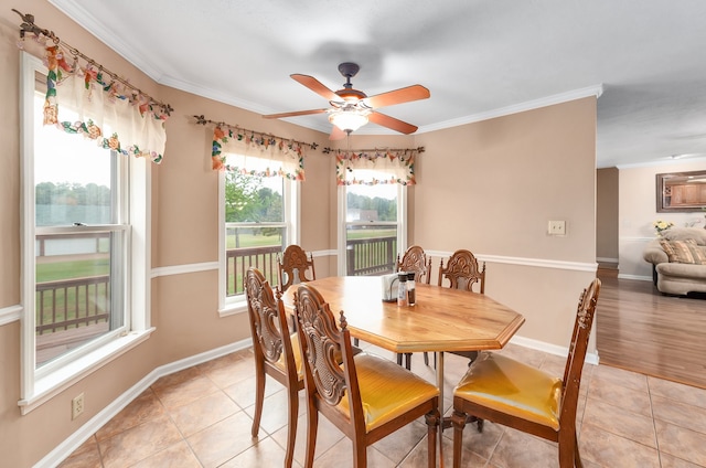 tiled dining area with ornamental molding and ceiling fan