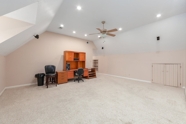 carpeted office space featuring ceiling fan and vaulted ceiling