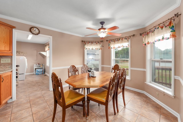 dining space featuring ornamental molding, ceiling fan, washer / dryer, and light tile patterned flooring