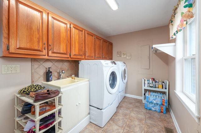 laundry room featuring cabinets, separate washer and dryer, sink, light tile patterned floors, and electric panel