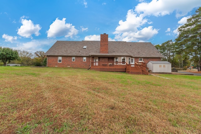 back of property featuring a lawn and a deck