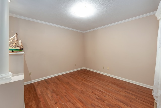 spare room featuring hardwood / wood-style floors and ornamental molding