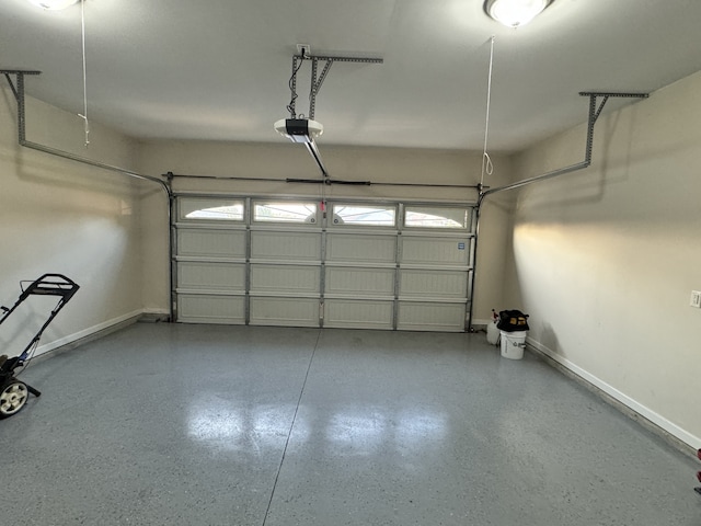 garage with baseboards and a garage door opener