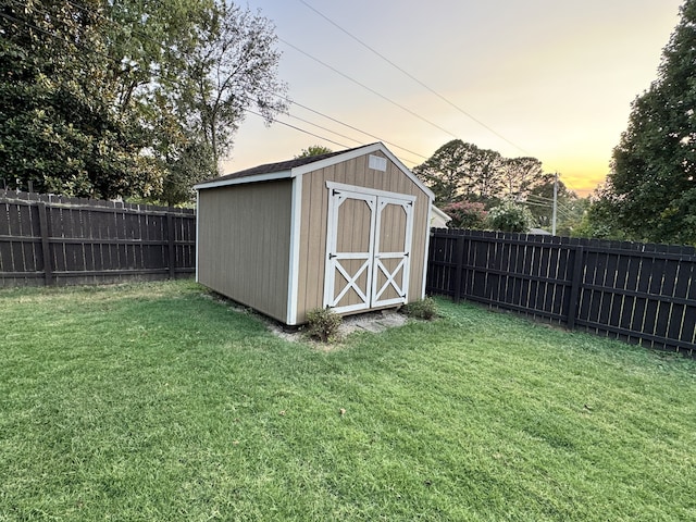 view of shed with a fenced backyard