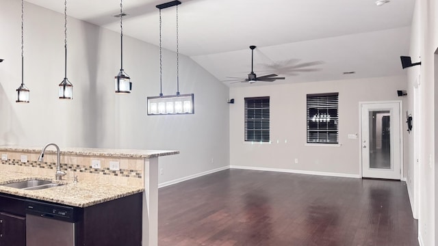 kitchen featuring decorative light fixtures, a sink, stainless steel dishwasher, and light stone countertops