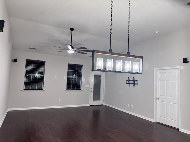 interior space with dark wood-style floors, visible vents, baseboards, and a ceiling fan