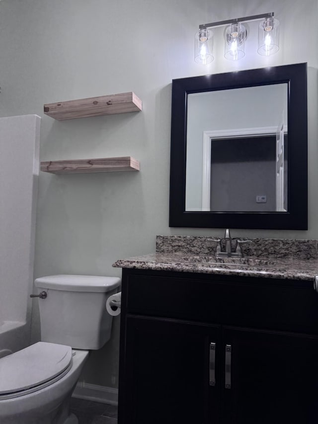 half bathroom with vanity and toilet