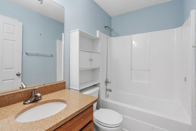 full bathroom featuring vanity, toilet, bathing tub / shower combination, and a textured ceiling