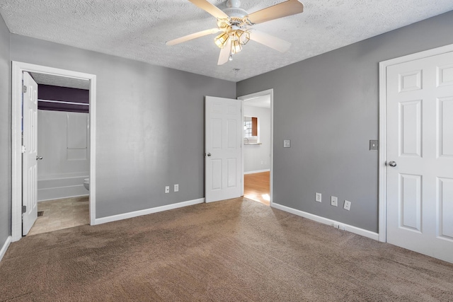 unfurnished bedroom featuring ensuite bath, a textured ceiling, ceiling fan, and carpet