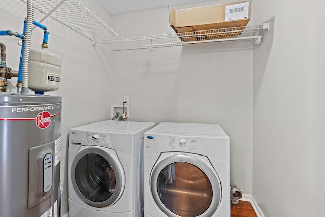 washroom featuring hardwood / wood-style flooring, independent washer and dryer, and water heater