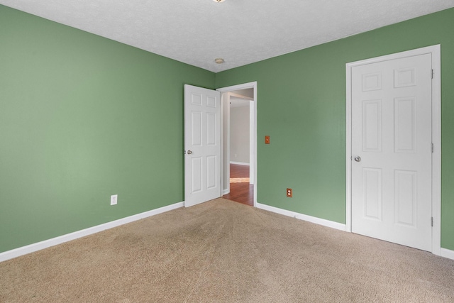 unfurnished bedroom with carpet flooring and a textured ceiling