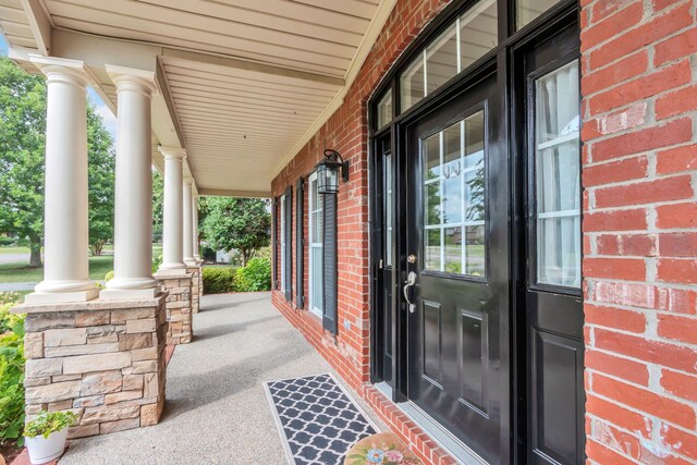 view of exterior entry featuring a porch