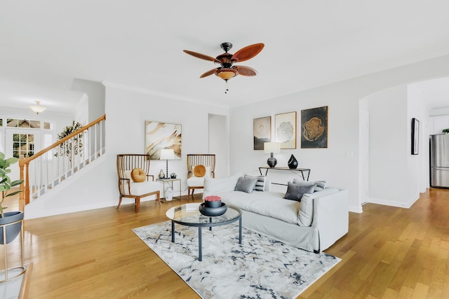 living room featuring hardwood / wood-style floors and ceiling fan