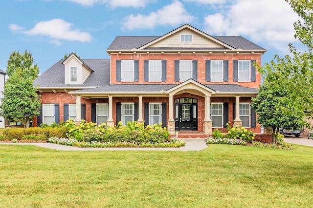 view of front of house featuring a front lawn and covered porch