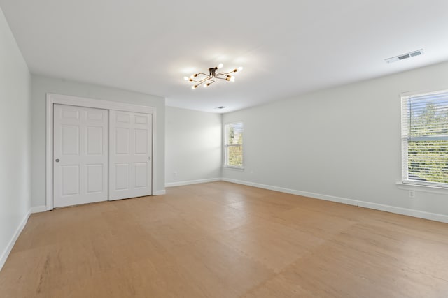 unfurnished bedroom featuring a closet and light wood-type flooring